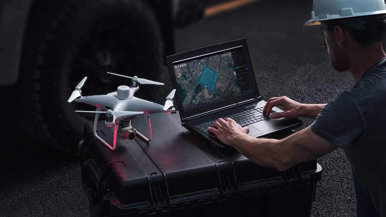 imagem de uma pessoa estudando mapeamento realizado ao lado de um drone profissional